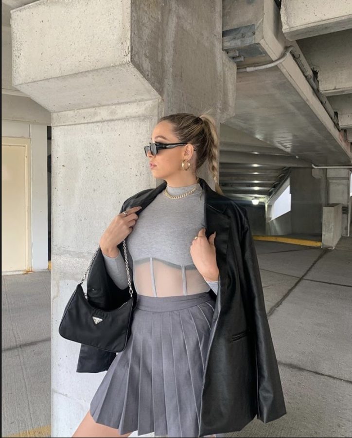 TikTok star and fashion influencer Rachel Clark wears a preppy tennis skirt with a leather jacket and shoulder bag. (Photo courtesy of Rachel Clark @rachelnoelllee on Instagram)

