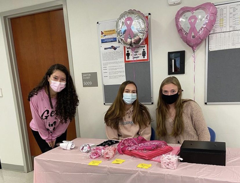 Nonnewaug students, from left, Lindiana Frangu, Jade Fortin and Erin Classey sell pink memorabilia during their lunch wave in order to raise money for Nonnewaug’s Go Pink Day fundraiser. 