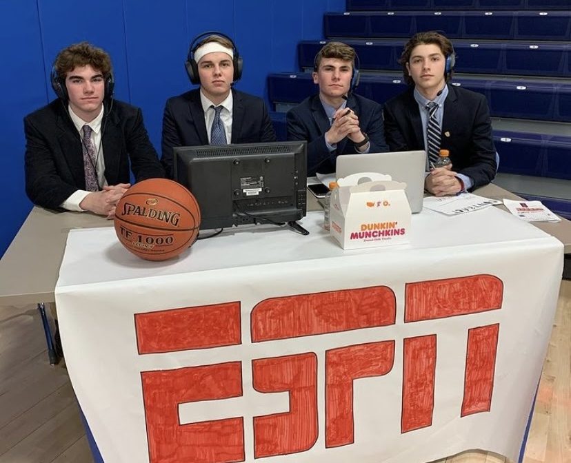 From left, Travis Bambino, Ryan Blanchard, Austin Bedard, and Gabe Brochu celebrated the boys basketball teams senior night last winter by posing as ESPN broadcasters.