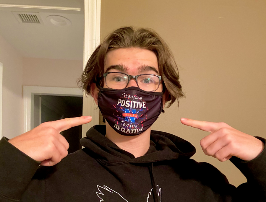 Senior James Vincent sports his Nonnewaug High school mask which reads, “Staying positive, testing negative.”