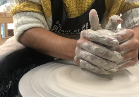 A student throws clay on the spinning wheel. This is one of the many activities at Nonnewaugs newest club, Ceramics Club.