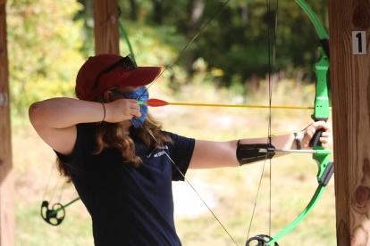 Pillis pulls back on a bow during archery practice at Boy Scout Camp. This is one of the many activities that make Pillis so versatile. 