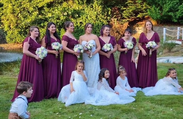 The bridal party holds bouquets made by Nonnewaugs floriculture class for the wedding of former aquaculture teacher Tyler Cremeans.