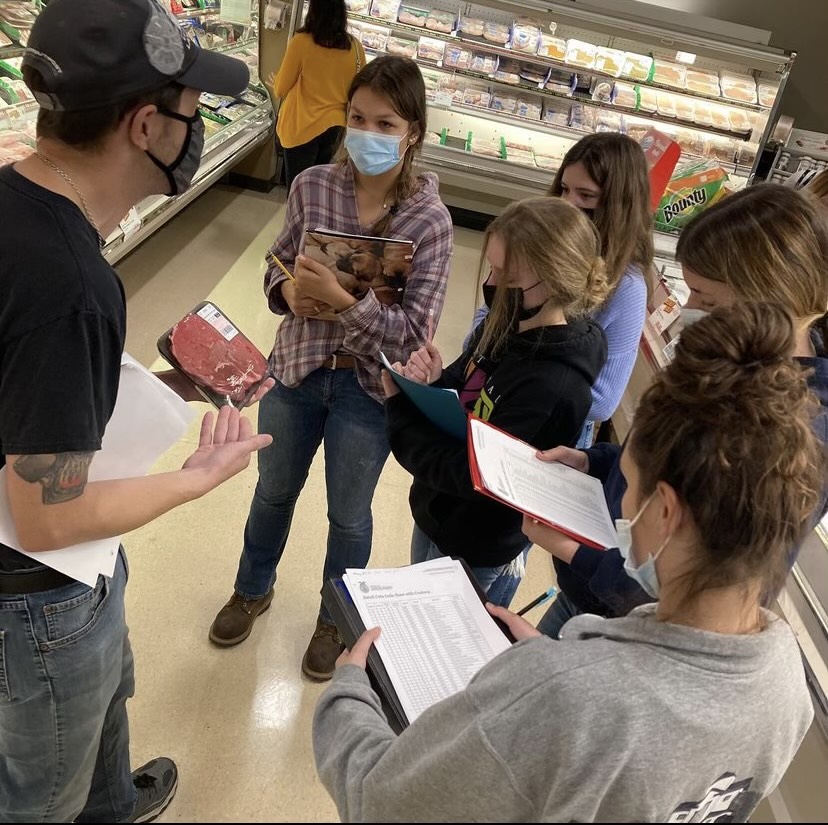 Sarah and members of the Meat Judging team take notes and learn from an employee at Labonnes before the 2021 state competition. Sarah is grateful for industry experts helping her deepen her passion for food science.