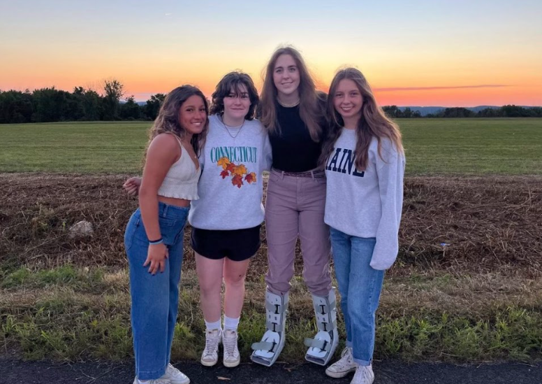 From the left to right, senior field hockey captains Jade DeLeo, Zoe Inglis, Madison Dannenhoffer and Jamie Paige pose for a picture taken on the first day of school, one month after Dannenhoffers accident. 