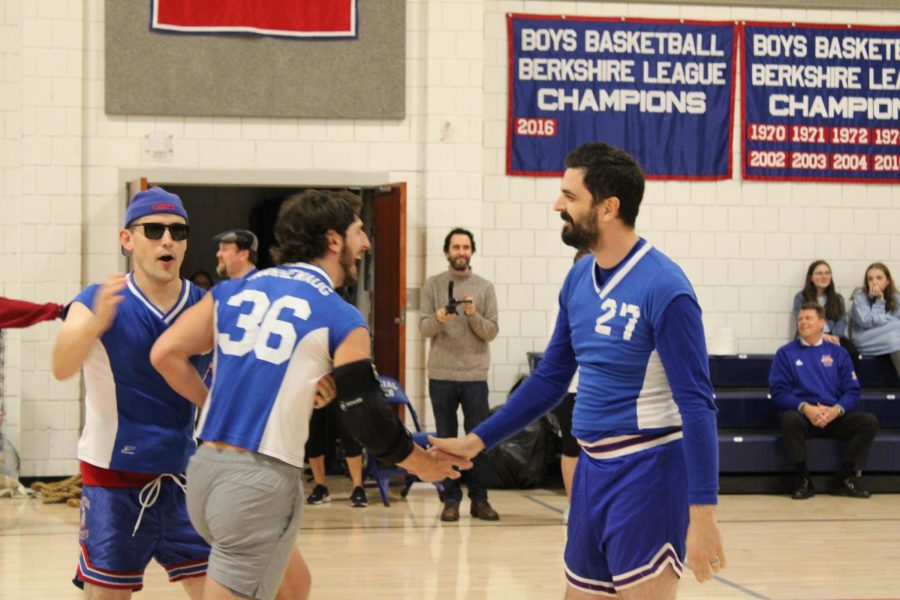 Math faculty, Marty Malaspina, celebrates with his colleagues following a point during the volleyball match against students. 