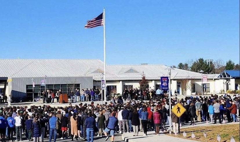 NHS students, staff, and participants of the annual Veterans Day ceremony gather around to listen to the music provided by the NHS band and choir. Poems and backstories were shared as the ceremony went on.