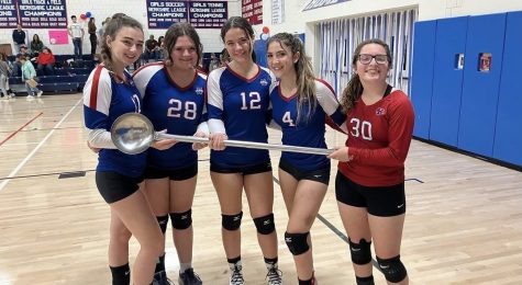 Volleyball seniors posing for a picture in the NHS gym on their senior night after their win against Wamogo. 
