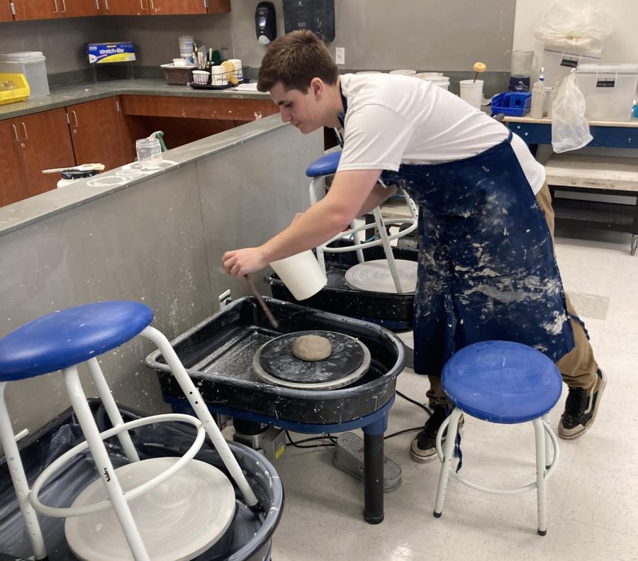 Ethan Moshier, who excels in ceramics, works with clay in the art room.