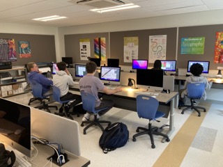 Digital design students work on Adobe Illustrator.