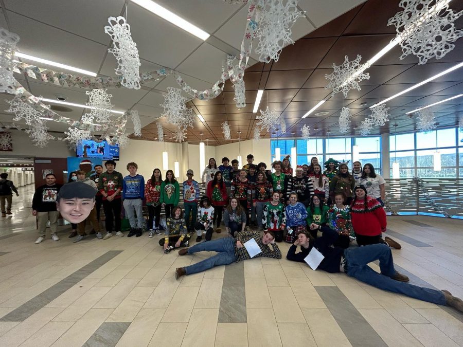 Nonnewaug+students+and+staff+members+who+wore+ugly+sweaters+on+the+Tuesday+before+holiday+break+gathered+in+the+lobby+for+a+photo.