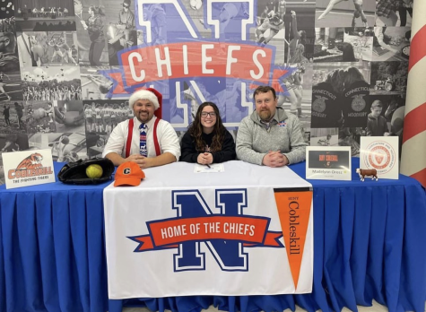 Maddie Orosz, center, poses for a photo next to social studies teacher Kyle Brannan, left, and athletic director Declan Curtin as she signs to play softball for SUNY Cobleskill next season. 