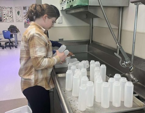 Committee members stayed after school April 21 to fill the color bottles that are used during the color blaze.