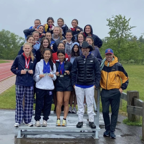 Coach Arleigh Duff poses with the girls track team after they went back-to-back and won their 24th Berkshire League title on May 20.