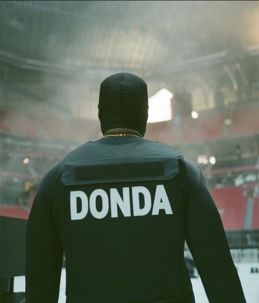 Kanye walks onstage, preparing to perform his new album, Donda, despite recent backlash over inflammatory comments. 