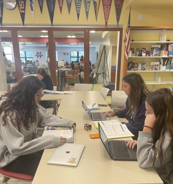 Seniors Sam Duncan, Skylar Chung, and Nicole Cappelli utilize the quiet environment of the Nonnewaug media center and CCRC during their period 5 study hall, in order to study for their AP courses.
