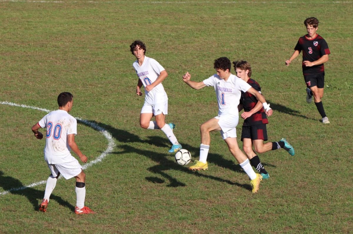 Nonnewaug junior Lincoln Nichols (1) moves the ball while being flanked by seniors Devon Zapatka (30) and Azem Frangu in a Sept. 27 game at Wamogo. (Courtesy of Nonnewaug boys soccer/Facebook)