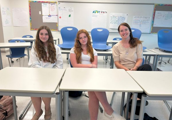 Freshman Class Council members Hannah Keating, left, and Paloma Koemp pose with advisor Rebecca Trzaski before they start their first meeting.