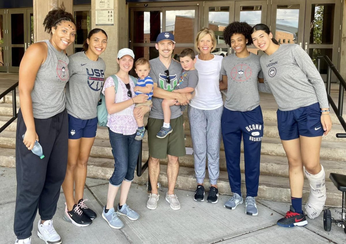 Conor Gereg, center, dons a mustache while he and his family met members of the UConn womens basketball team over the summer. (Contributed by Conor Gereg)