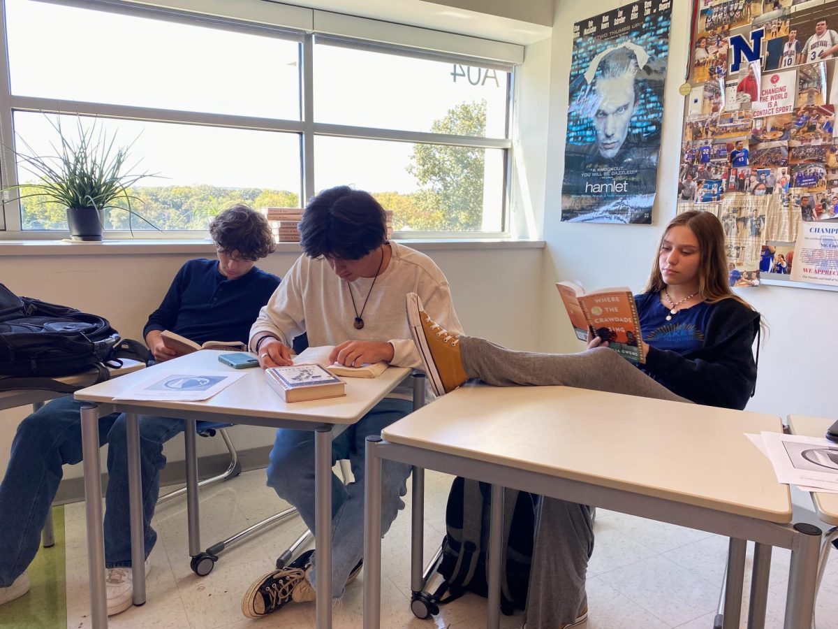 A group of senior students at Nonnewaug High School reading during the silent reading portion of their English class.