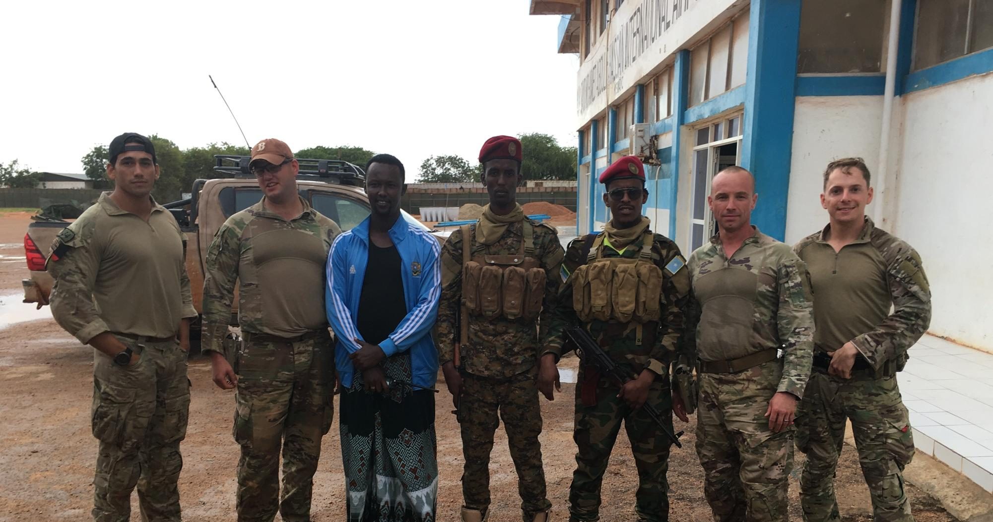 Mykal Kuslis, second from right, poses with members of his platoon and local soldiers during his National Guard deployment in Africa. (Courtesy of Mykal Kuslis)