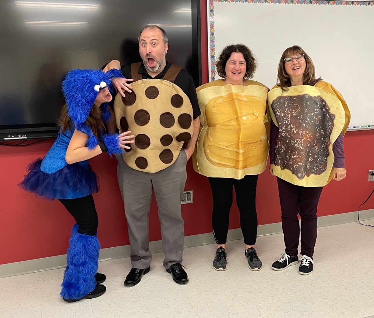 Math+teachers%2C+from+left%2C+Jamie+Lisevick%2C+Ray+Robillard%2C+Nicole+Cowles%2C+and+Laurenn+Bertoglio+pose+as+the+Cookie+Monster%2C+a+chocolate+chip+cookie%2C+and+a+peanut+butter+and+jelly+sandwich+Oct.+17.+It+was+the+second+day+of+fall+spirit+week%2C+Dynamic+Duo+Day.