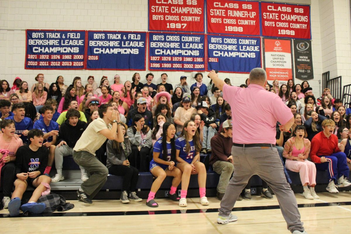 The junior class yells during the screaming contest at the end of the fall pep rally Oct. 19 while Toby Denman measures the volume. (contributed)