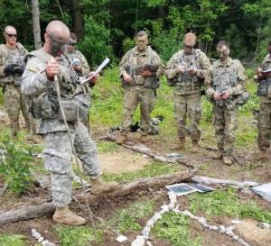 Mykal Kuslis leads his platoon during training for the National Guard. Kuslis, Nonnewaug's new principal, is still a member of the National Guard -- one of many facts of his unique background. (Courtesy of Mykal Kuslis)