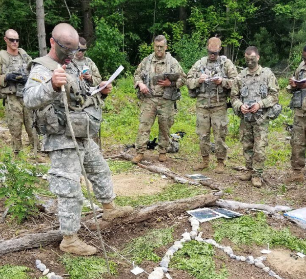 Mykal Kuslis leads his platoon during training for the National Guard. Kuslis, Nonnewaug's new principal, is still a member of the National Guard -- one of many facts of his unique background. (Courtesy of Mykal Kuslis)