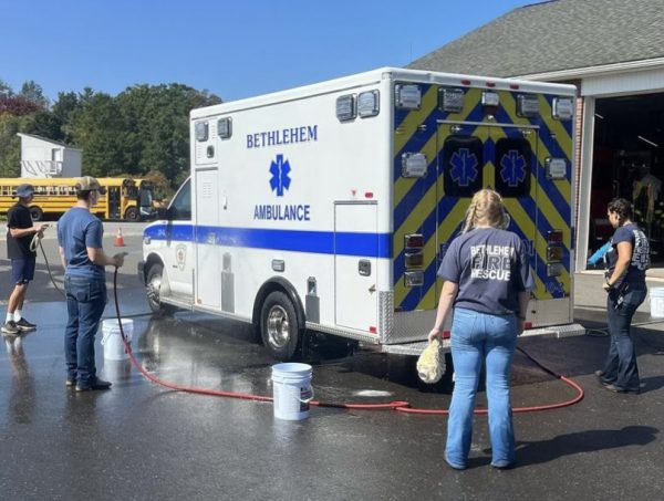 The Bethlehem and Woodbury fire departments junior corps wash an ambulance as part of a fundraiser for a new AED at Nonnewaug.