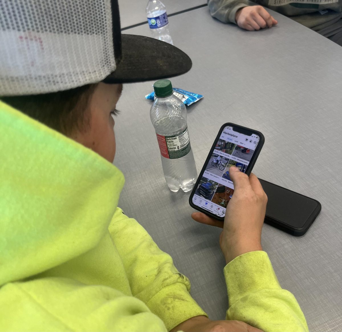 Junior Nicholas Mancini using his lunch period at Nonnewaug to scan through Facebook Marketplace, the typical buying platform for most students, as he looks for a truck to buy. Most students will make their first big purchase from browsing through this platform.
