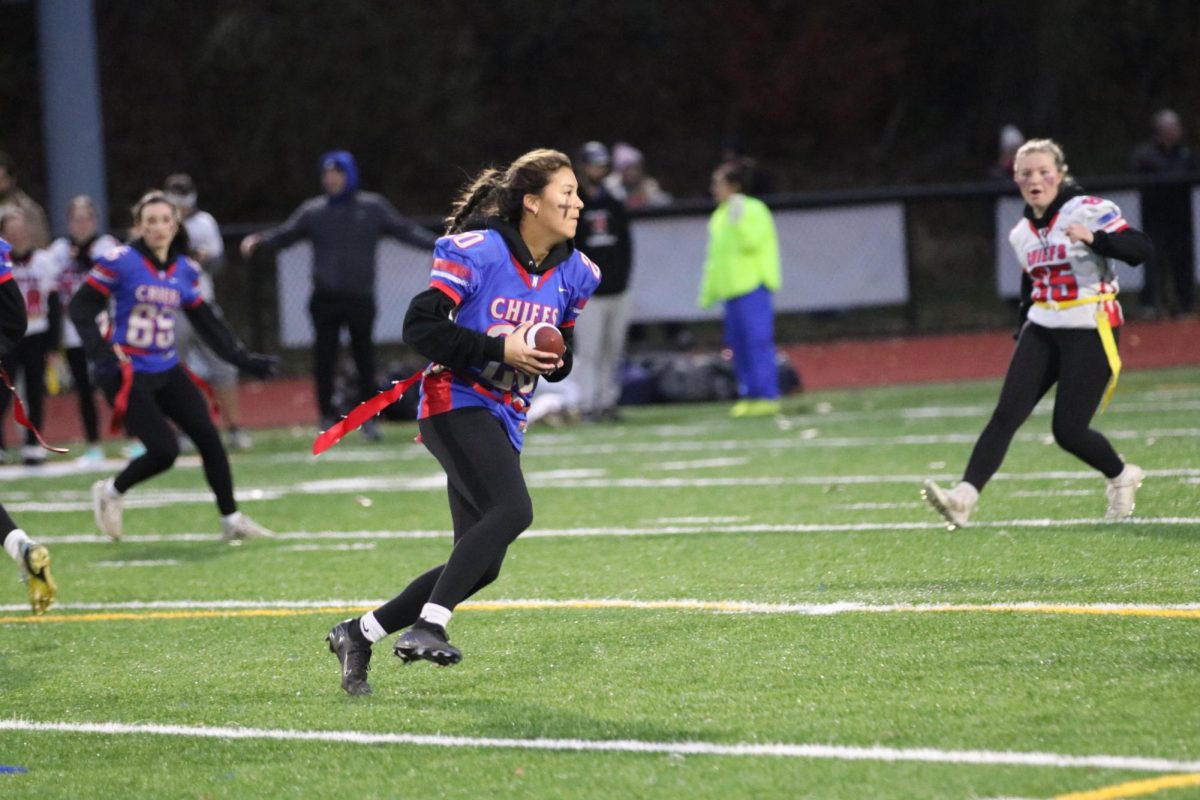 Senior Skylar Chung runs with the ball during the Powderpuff game Nov. 21. Chung was named MVP with two interceptions, including a pick-six.