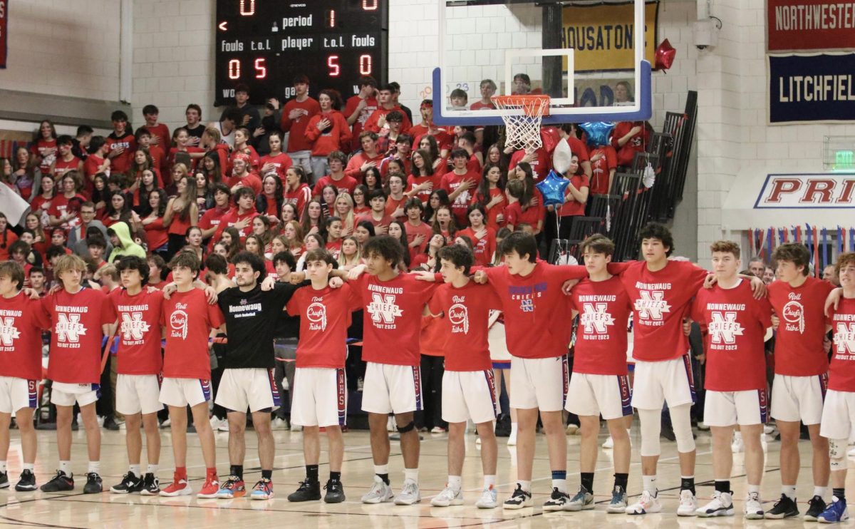 The Nonnewaug boys basketball team and student section dress in red vs. Shepaug last season. The redout theme supports the Leukemia and Lymphoma Society. (Courtesy of Noreen Chung)