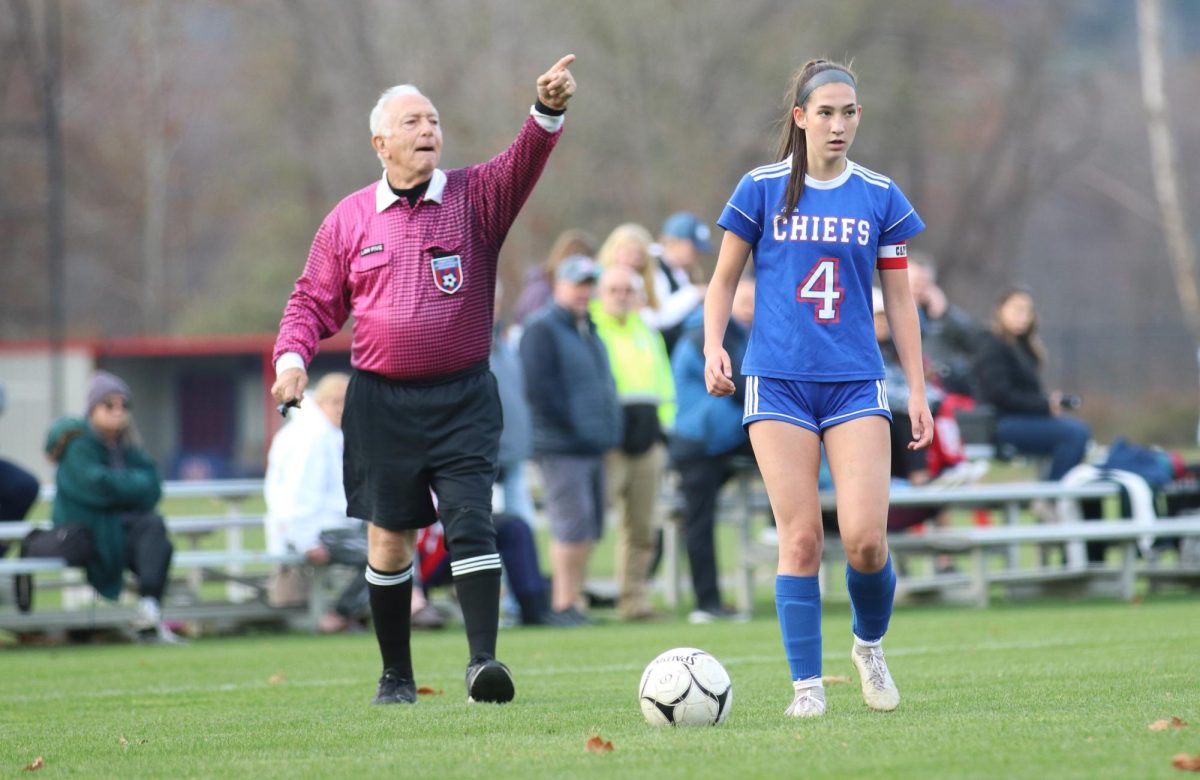 A referee signals after making a call during Nonnewaugs Class M girls soccer state tournament first-round game against New Fairfield on Nov. 6 as Layla Coppola prepares to put the ball back in play. Coppola is one of many student-athletes who express frustration about officiating. (Courtesy of Noreen Chung)