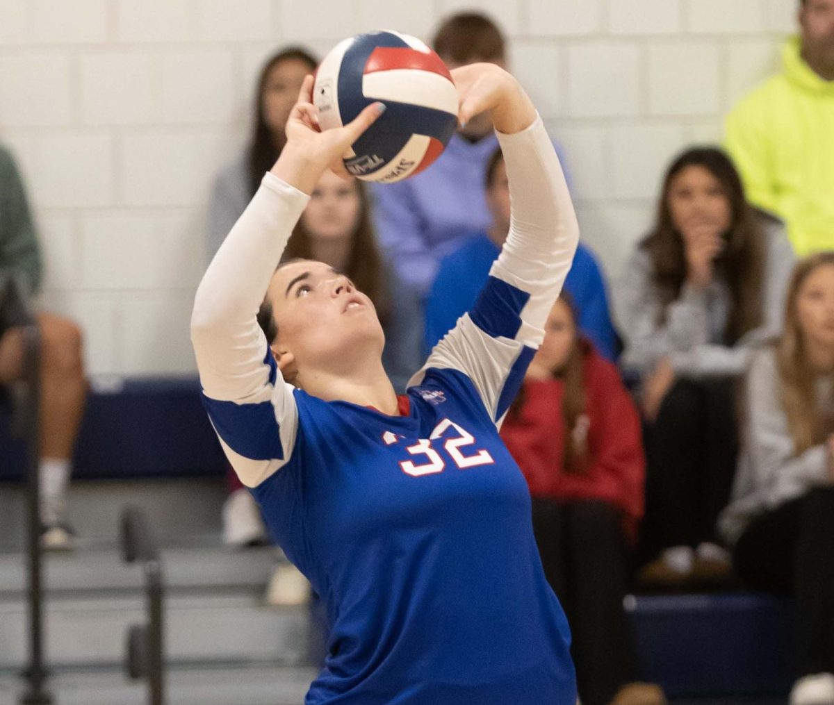 Emma Jackson sets a ball during a volleyball game this fall. Jackson, a junior, is a student-athlete and an agriscience student.
