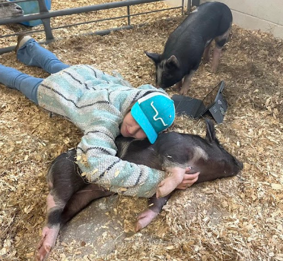 Senior, Caroline Kyrytschenko, is a student in Kathleen Gorman’s Ag Production class.  Caroline cuddles with the pigs, exercising the pigs brain’s and social skills.  She does this in hope that the program raises more friendly livestock for the NHS ag animal lab.