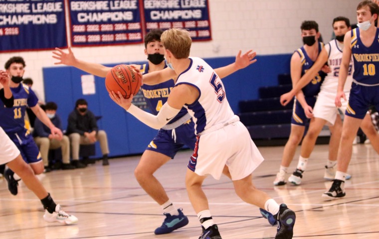 Ben Conti searches for a pass in the teams game against a tough loss from Brookfield High School with a score of (63-37). 