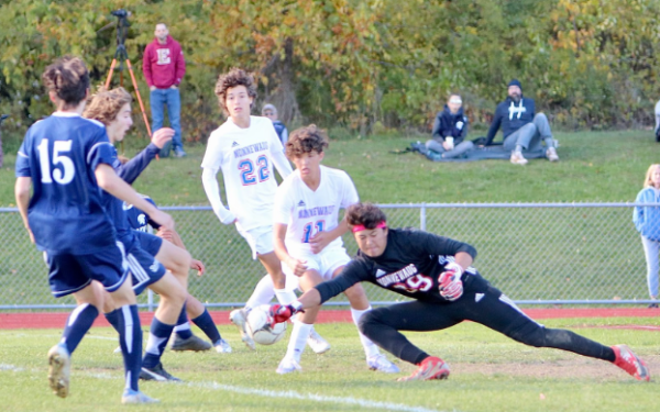 Nonnewaug’s Dylan Chung during a rough save against Shepaug soccer,  2022. Going for a save as a goalie takes a lot of courage, especially when you have the whole team against you— for Dylan it wasn’t even a thought. 