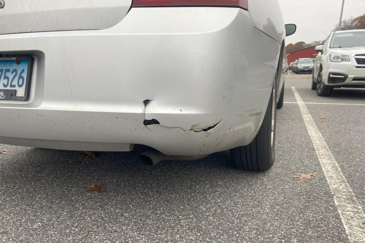 A car in the senior parking lot has a cracked bumper. Some new drivers at Nonnewaug worry about being hit in the parking lot.