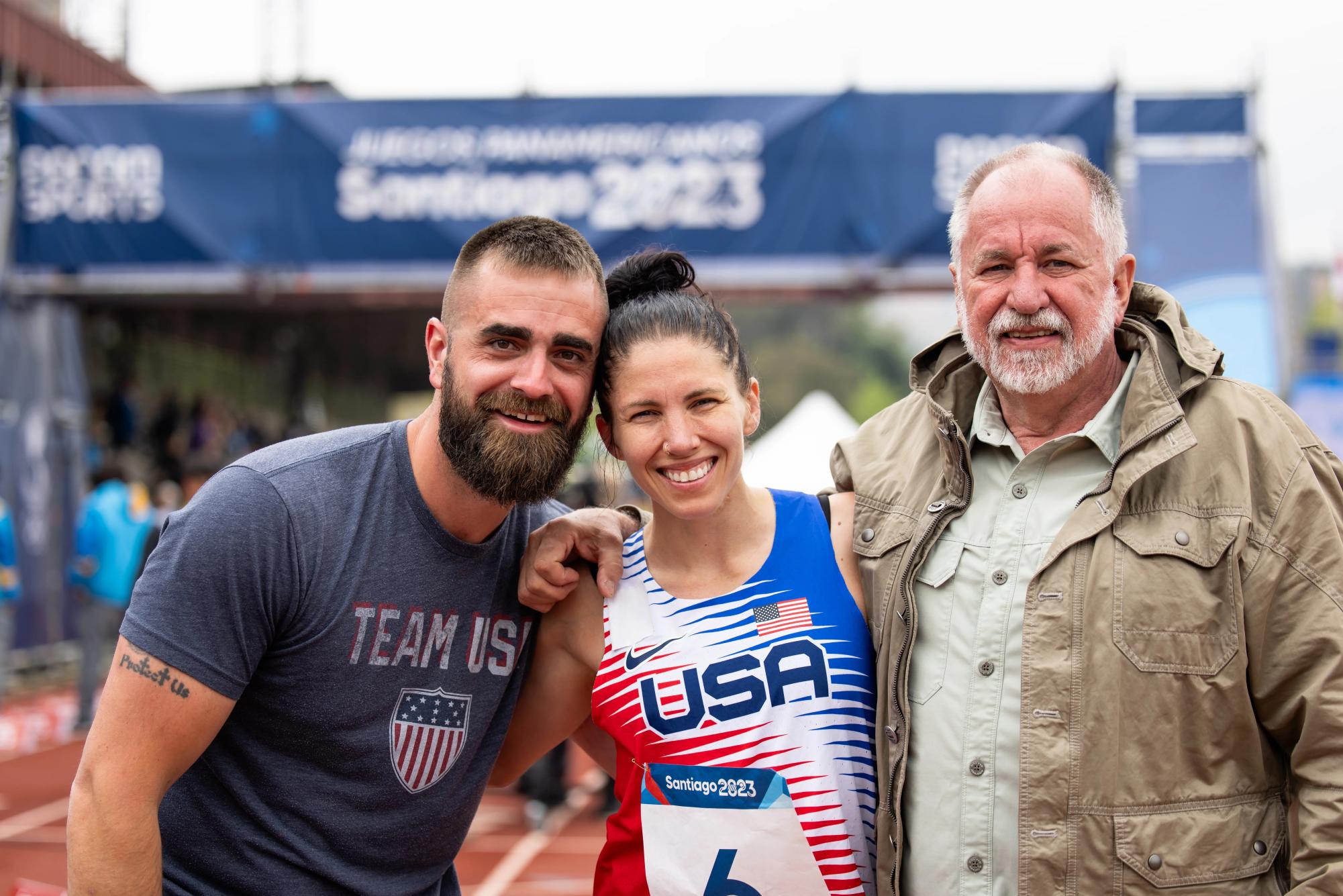 Jess Davis, center, celebrates with her husband and father after competing in the womens modern pentathlon final during the Pan American Games Santiago 2023 on Oct. 23, 2023 in Santiago, Chile. (Courtesy of Joe Kusumoto/U.S. Modern Pentathlon)