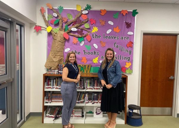 Library assistants Dawn Maletzke, left, and Stephanie Deering show off the new bulletin board outside the LMC, decorated just in time for the end of the fall season.