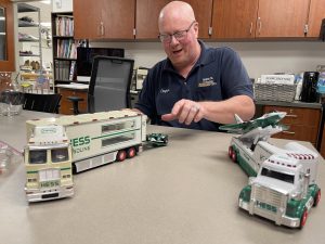 Custodian Clayton Hilpertshauser helps set up a still-life set for Nonnewaug art students. His impact at NHS doesn’t end with merely maintaining the building.