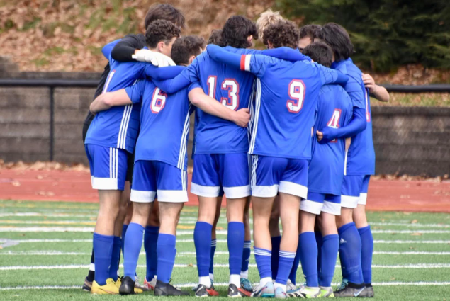 Nonnewaug boys soccer starters stand in a huddle before their game. This 2023 team, although down 13 seniors from last season, proved to be more successful than people had thought possible.
