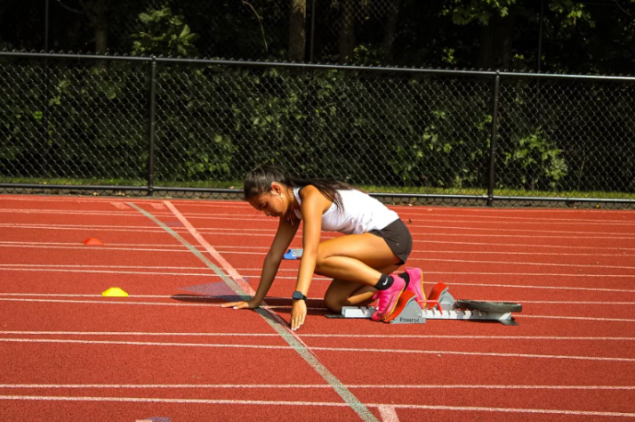 Junior Ellie McDonald gets ready to practice her block starts at track practice. This hard work, combined with her speed, is what makes McDonald stand out from other athletes. (contributed)