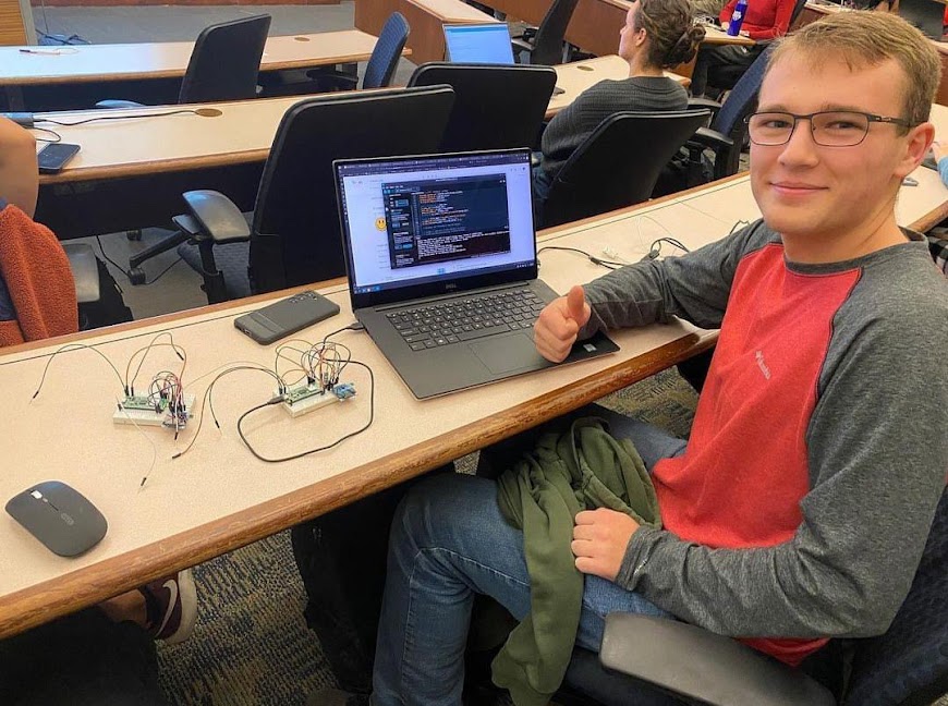 Jack Rubacha poses after finishing coding a program for his engineering class. Rubacha, the Nonnewaug class of 2023 salutatorian, is a freshman at Northeastern University.