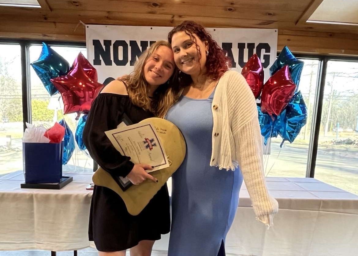 Grace Rubacha, left, poses with swim coach Abby Walsh after receiving her Golden Kickboard award. The Golden Kickboard is awarded to swimmers that show a high level of sportsmanship and teamwork. (contributed)