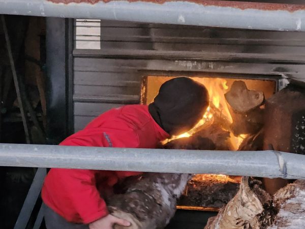 T.J. Butkus loads his wood furnace to try to keep warm during the winter. (contributed)