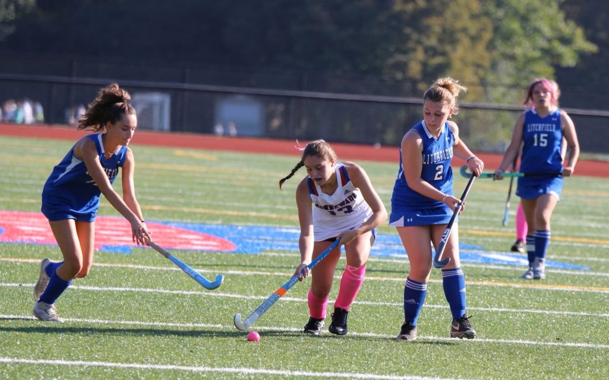 Hannah Searles (center) advances the ball up the field during a field hockey game this season. Searles only started playing the sport because the Chiefs needed more players, but teammates quickly became impressed with her work ethic. (contributed)