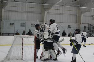 The Spartans celebrate after scoring the final goal of the night as Shepaug beat Fox Lane on Feb. 5.