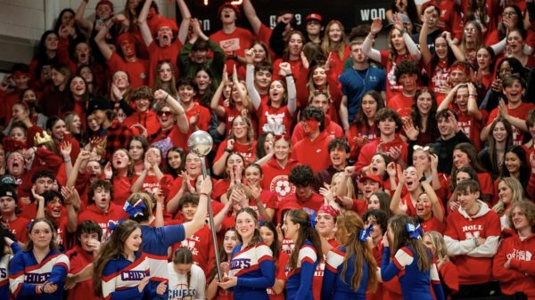 The Nonnewaug cheerleaders hype up the Chiefs red-out student section during the boys basketball game against Shepaug on Feb. 2.